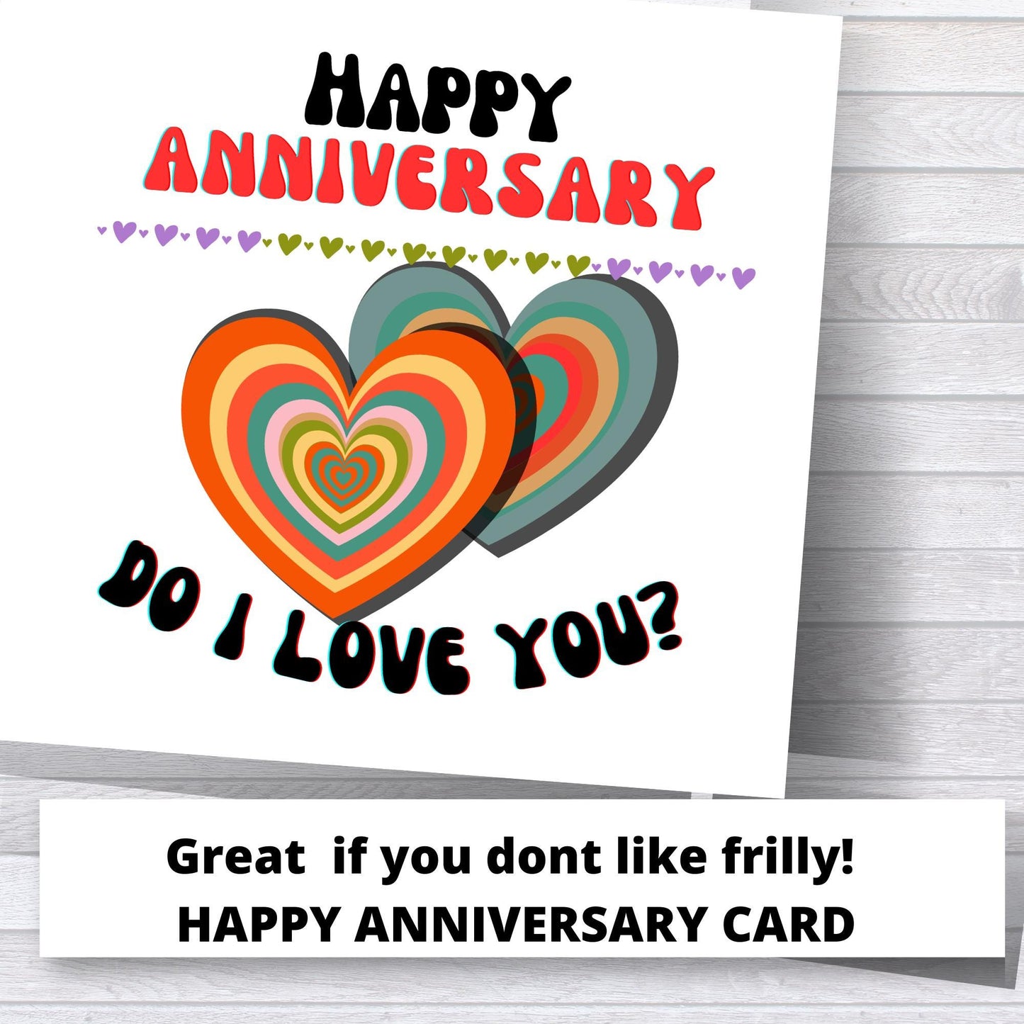 Happy Anniversary card with colorful hearts and text on a wooden surface