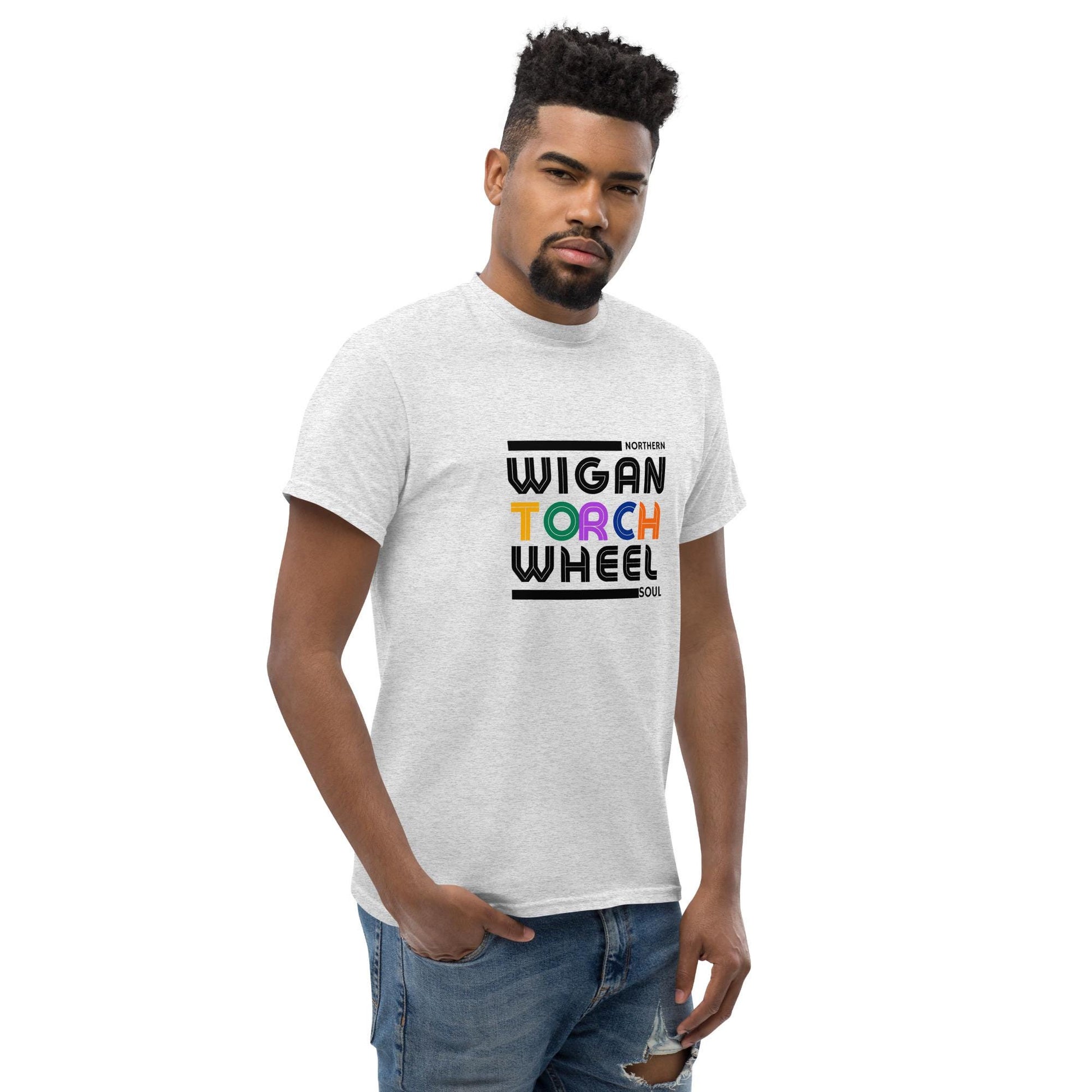 Man wearing a white t-shirt with 'Wigan Torch Wheel' text design on a white background