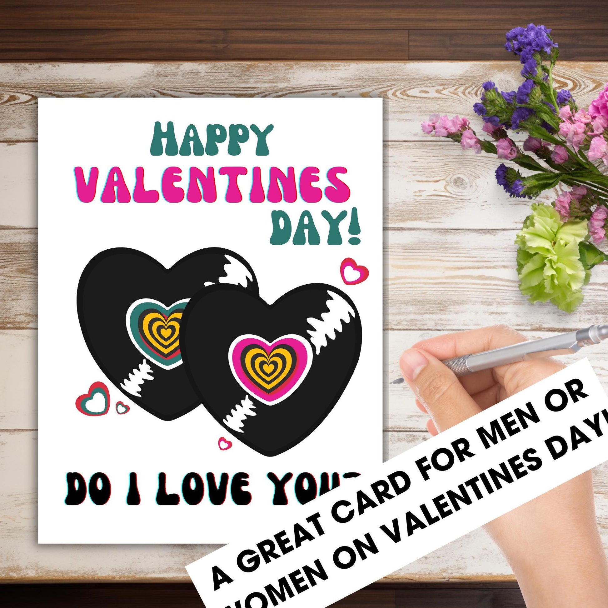 Valentine's Day card with hearts and text on a wooden surface with flowers.