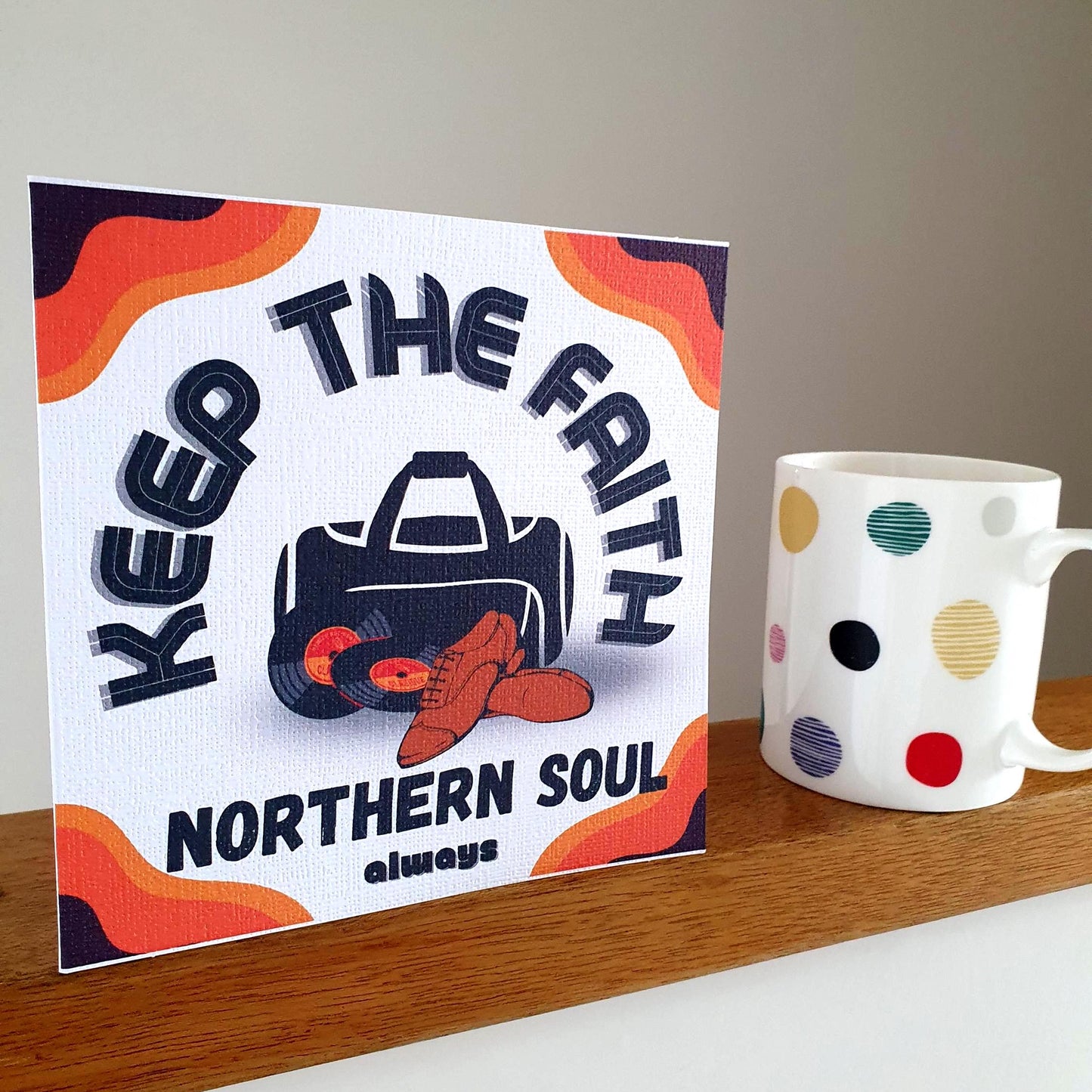 Birthday card with 'Keep the Faith Northern Soul' design on a shelf next to a polka dot mug.