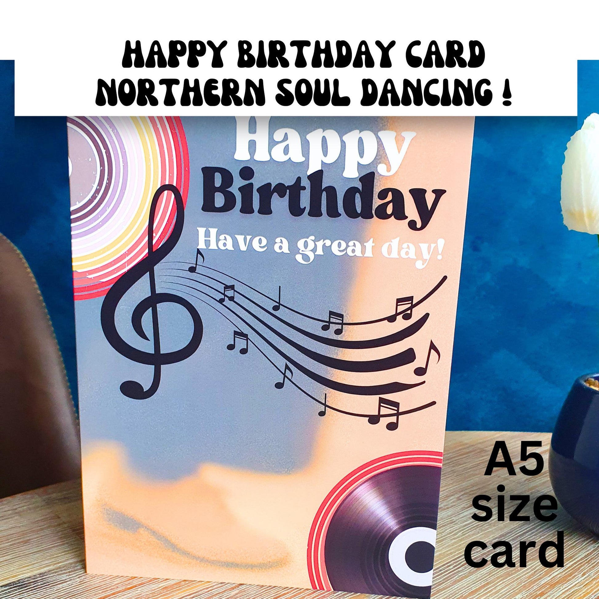 Happy Birthday card with mens trousers and shoes and music notes and record design on a wooden surface