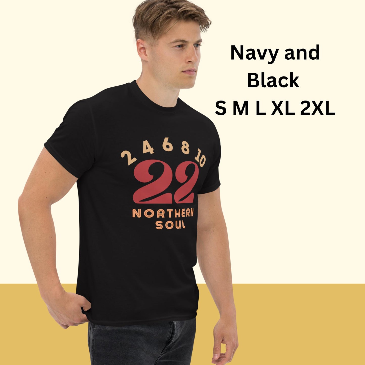 Man wearing a black t-shirt northern soul tee shirt with red and orange text and numbers on a beige background