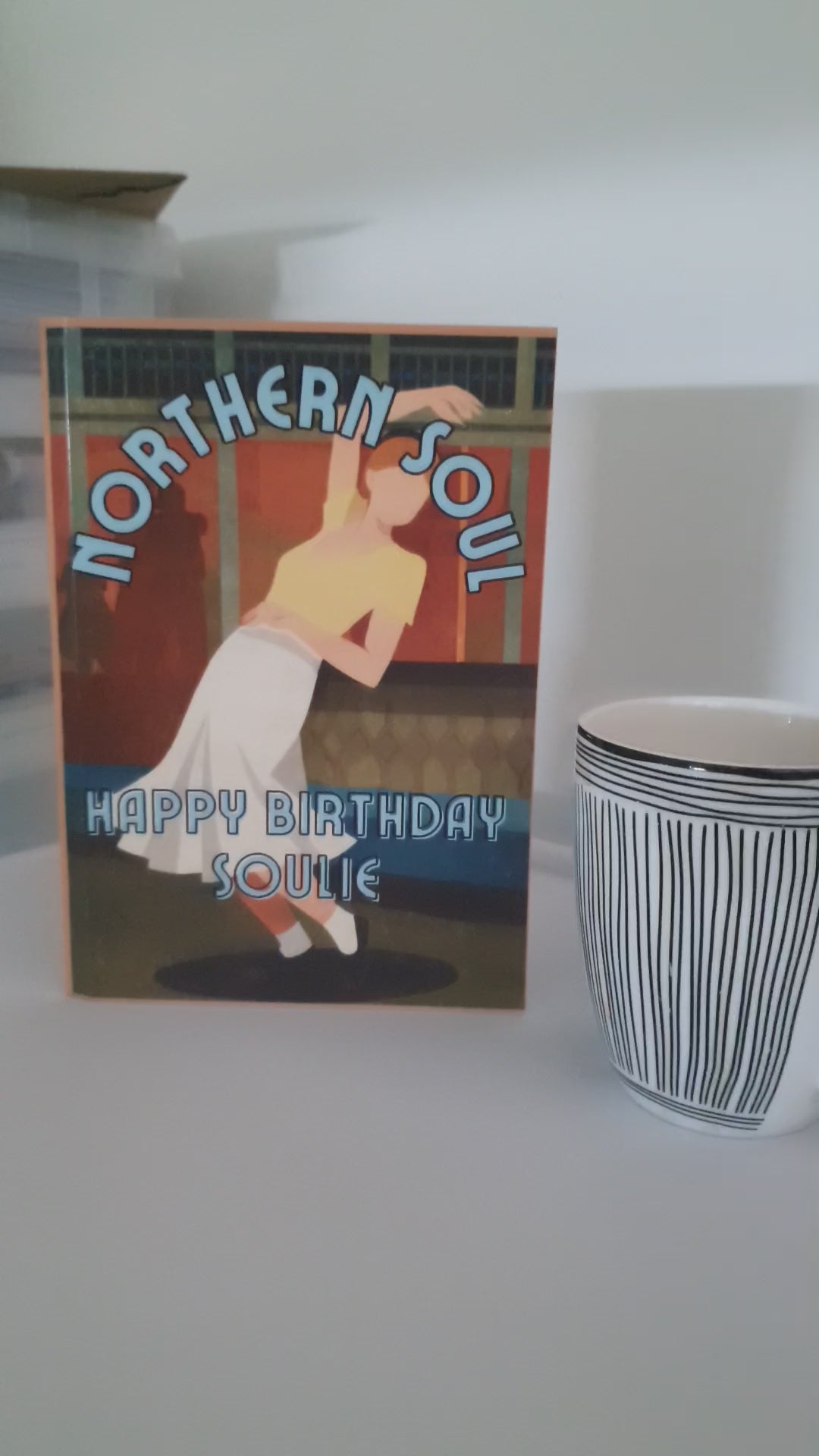 video of northern soul birthday card alongside a coffee mug