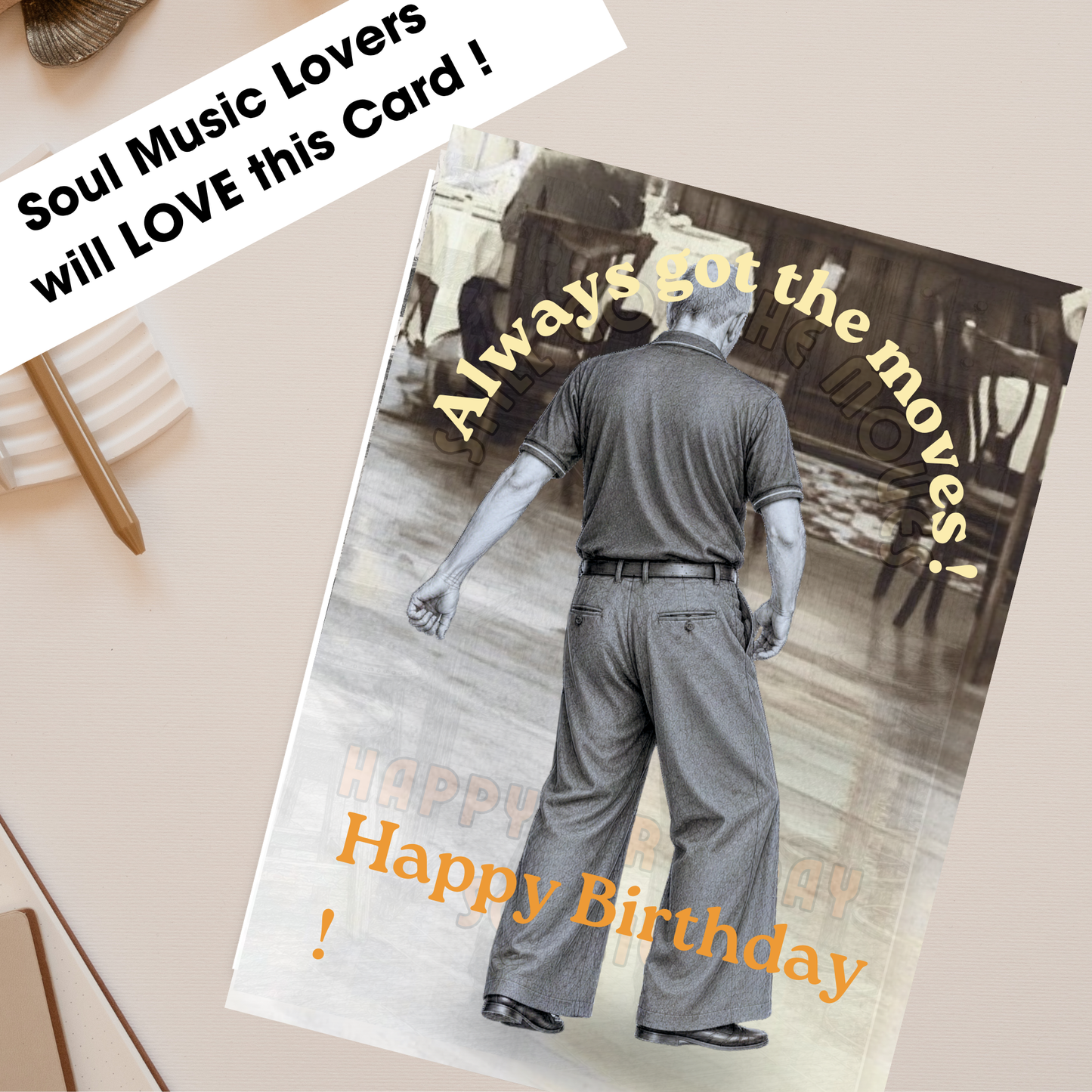 a card on a plain desk with a pencil nearby depicting the monochrome image of northern soul man middle aged in polo shirt and wide leg trousers dancing with text stating always got the moves
