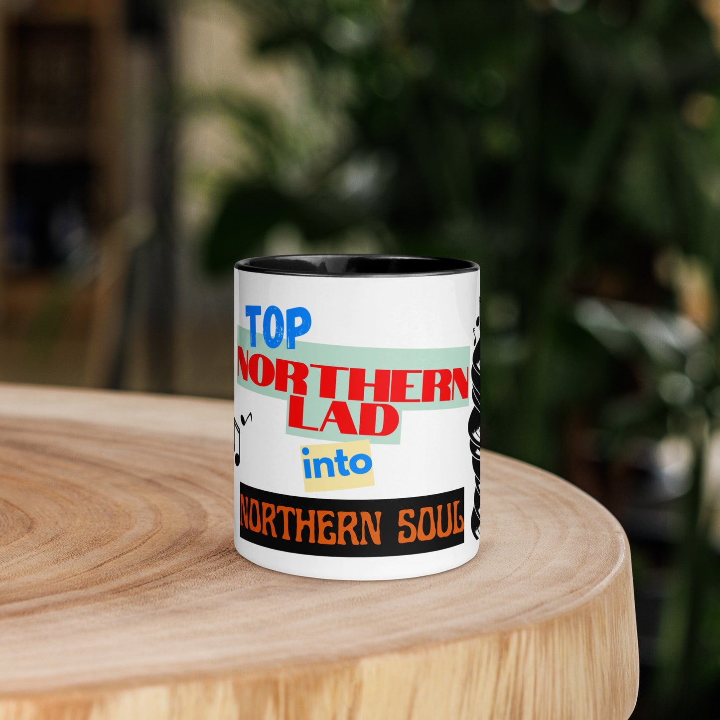 Mug with colorful text design stating northern lad into northern soul on a wooden surface