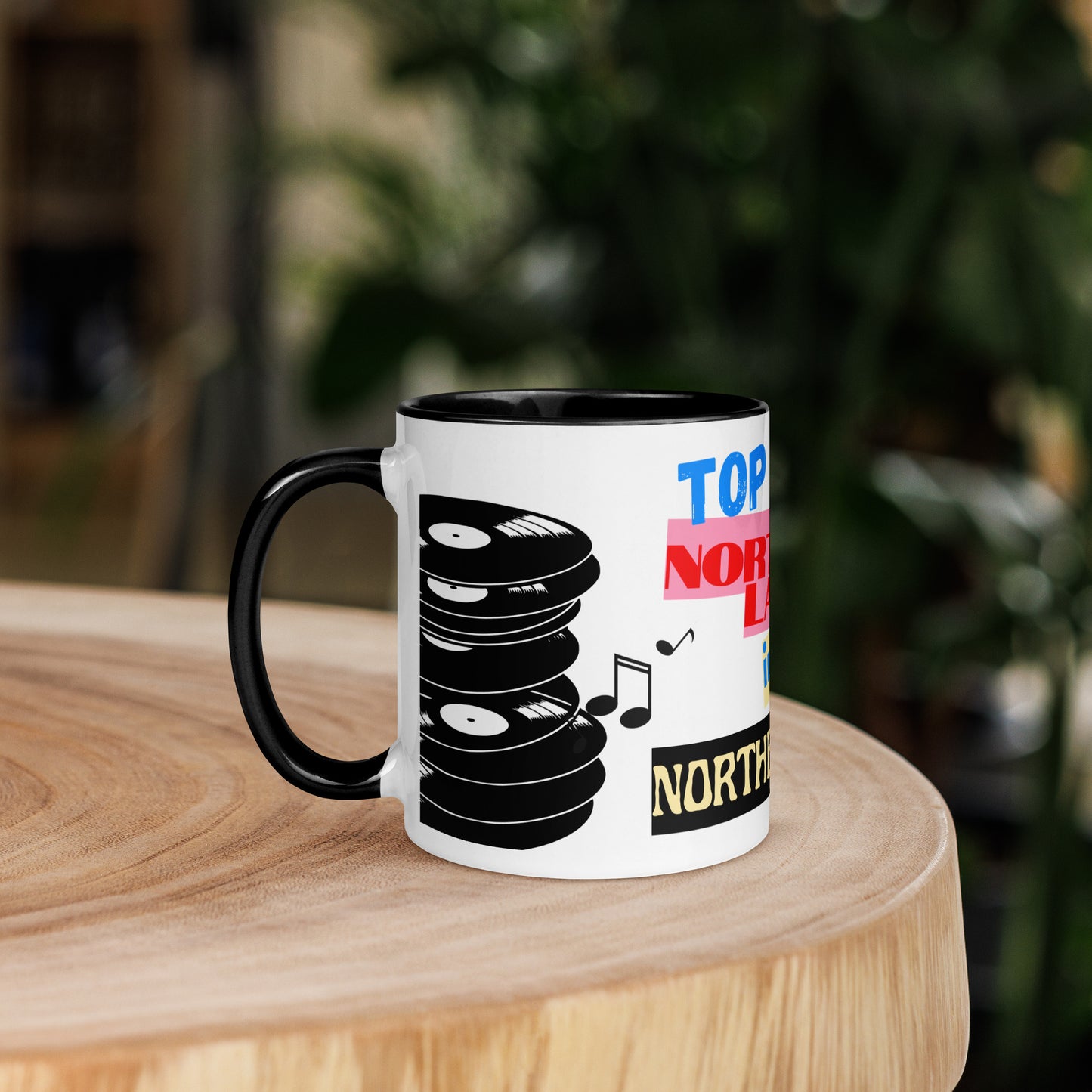 Mug with vinyl record design and text on a wooden surface