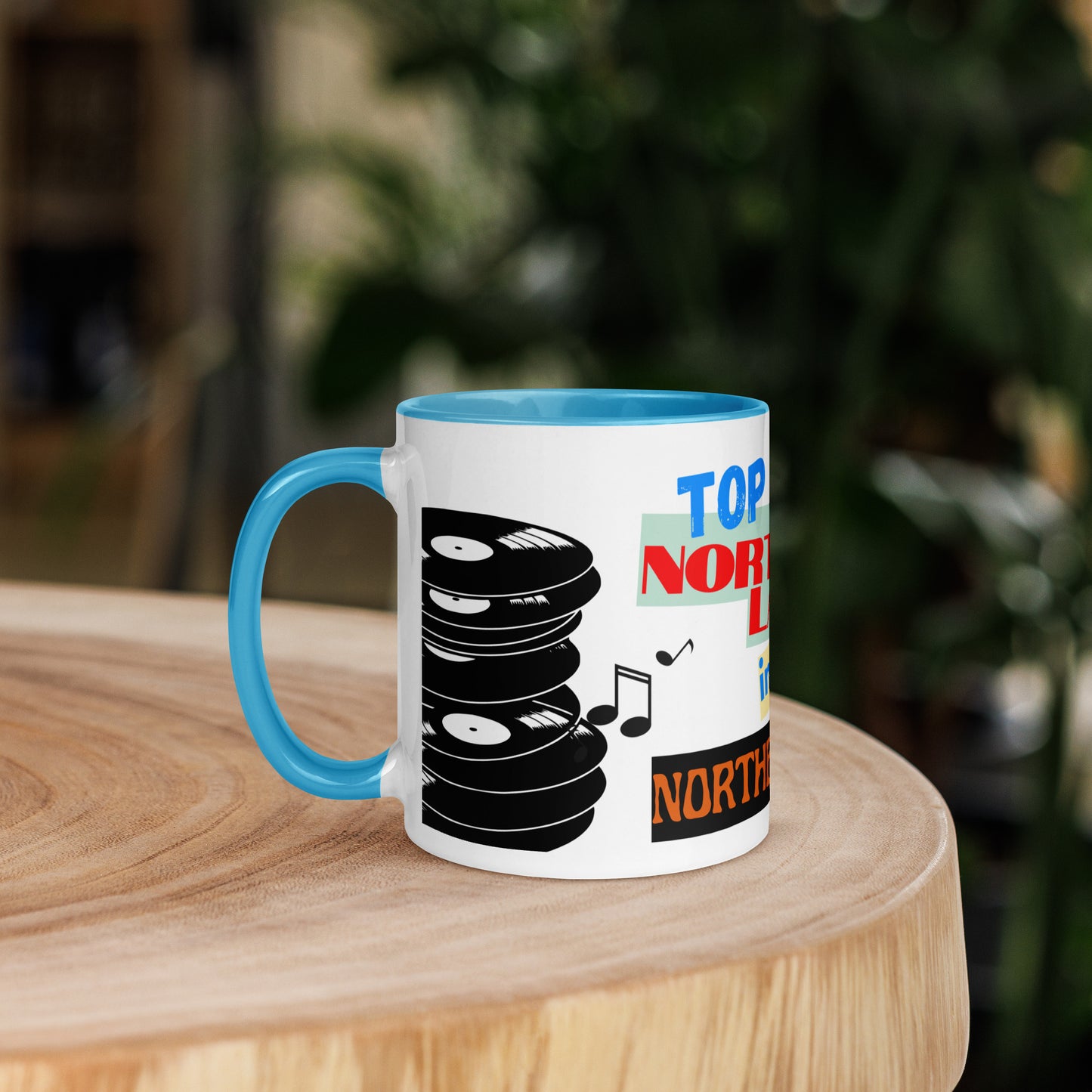 Mug with vinyl record design and 'Top Northern Lad ' text on a wooden surface