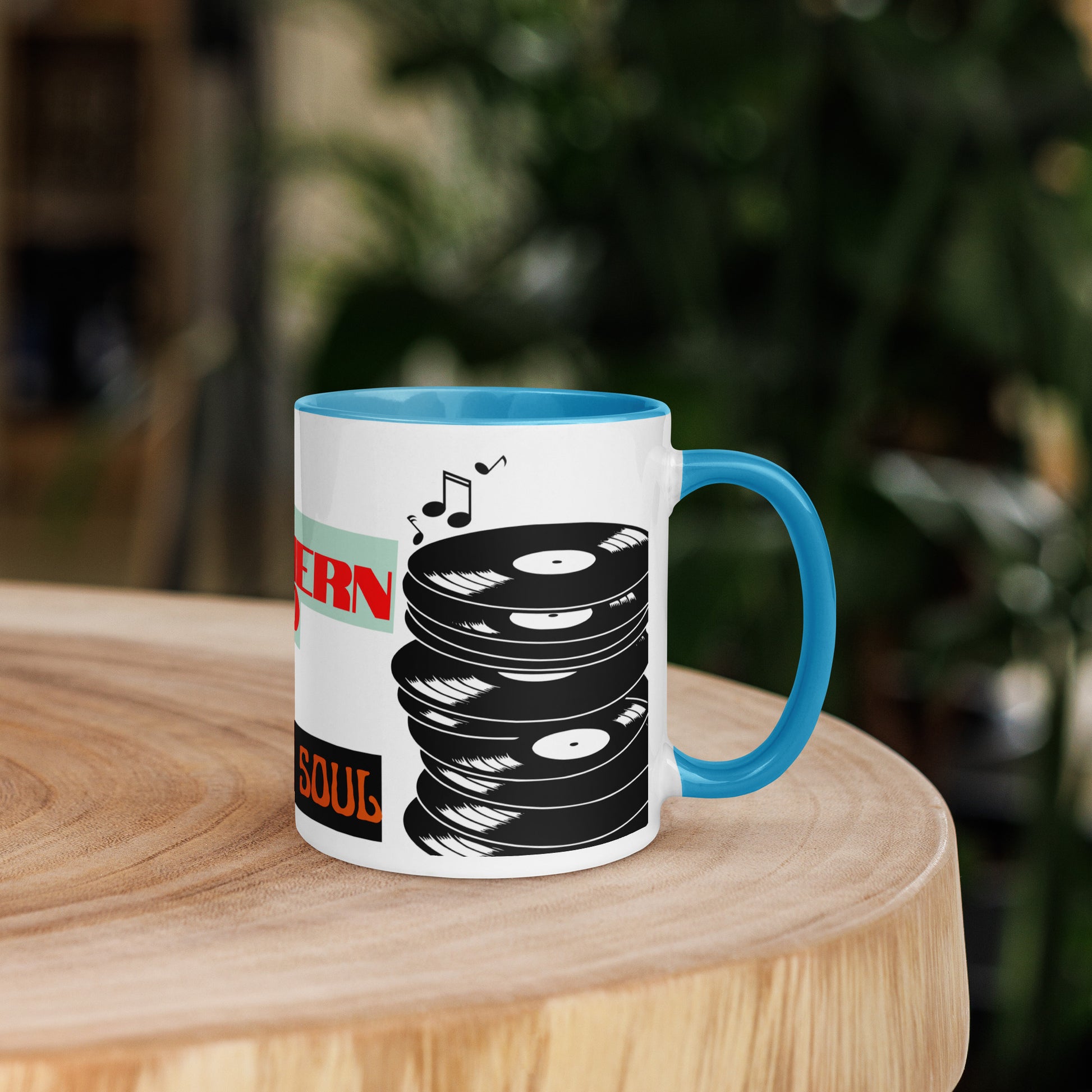 Mug with blue inner on white outer with vinyl record design on a wooden surface