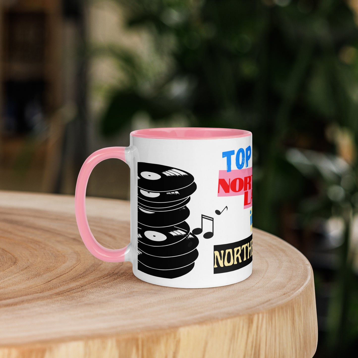 white with pink Mug with vinyl record design and text on a wooden surface